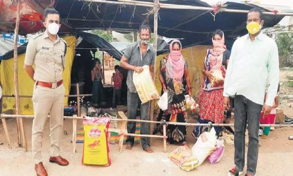 Gadag SP Yatish N distributes groceries to a migrant family