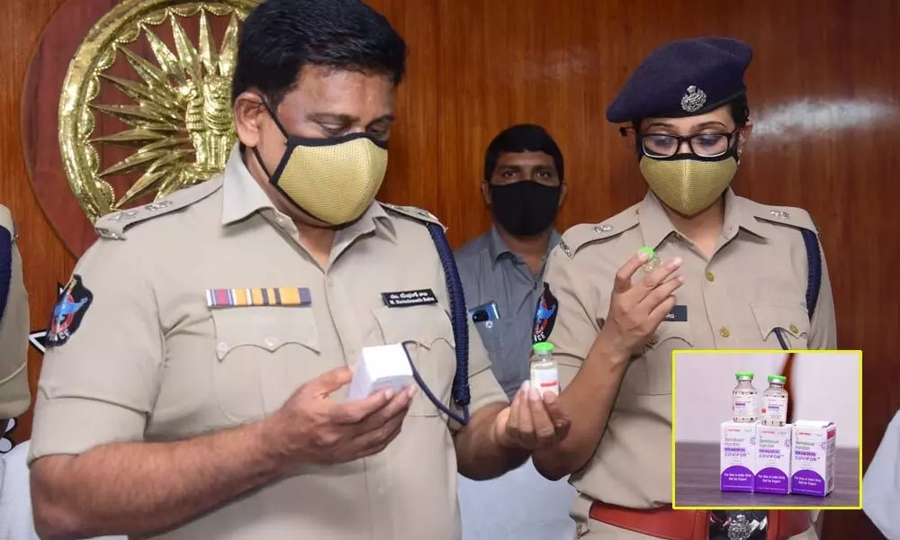 SP M Ravindranath Babu with seized Remdesivir injections in Machilipatnam on Tuesday. Additional SP Malika Garg also seen.