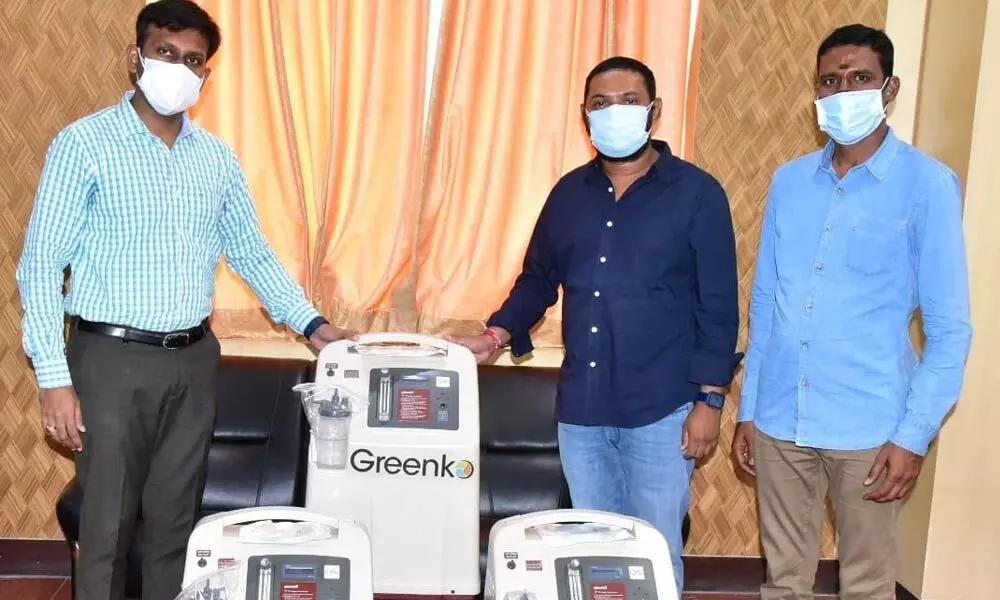 Greenko Foundation representatives handing over oxygen concentrators to District Collector Ch Harikiran in Kadapa on Tuesday