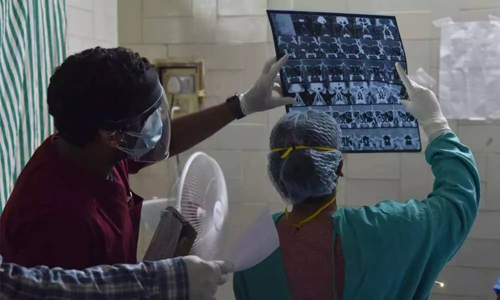 Doctors examining nasal endoscopy reports to detect black fungus at ENT Hospital in Hyderabad on Thursday. Photo: Srinivas Setty