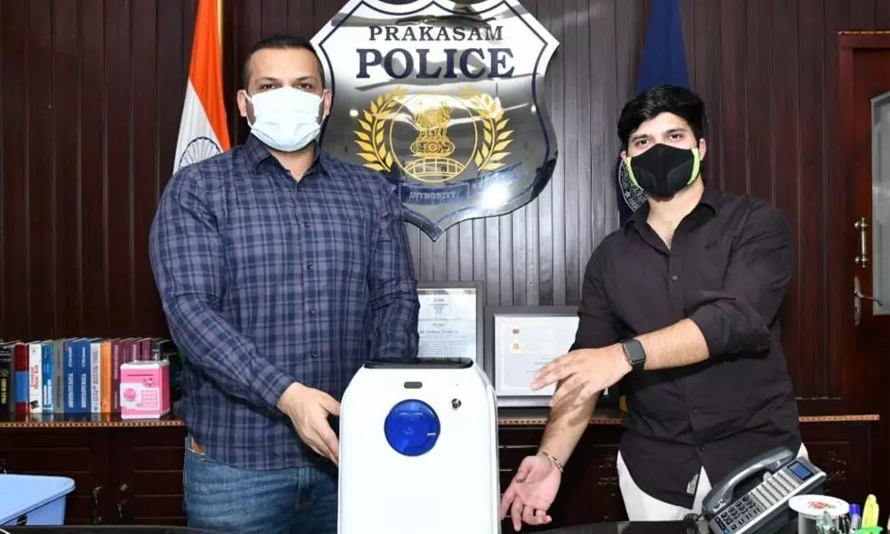 Bommisetty Arjun of BMR Gold and Diamonds presenting the oxygen concentrator to SP Siddharth Kaushal in Ongole on Thursday