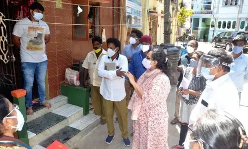 GVMC Commissioner G Srijana examining door-to-door fever survey in Visakhapatnam.