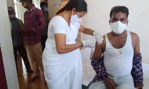 ANM Annapoorna administering Covid vaccine to a person at RRB Puram PHC in Jiyyammavalasa mandal in Vizianagaram district