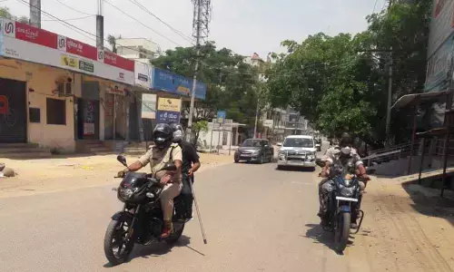 Police officials taking out a bike rally to monitor lockdown situation in Bodhan town on Saturday