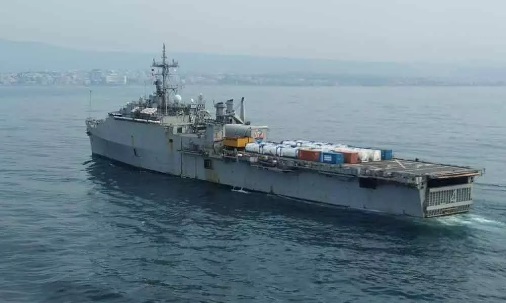 INS Jalashwa arrives with Covid relief material in Visakhapatnam on Sunday.