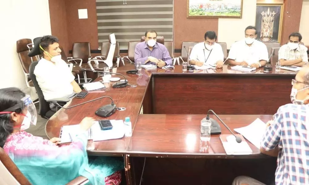 MCT Commissioner P S Girisha conducting a review meeting with officials over planting of saplings as part of the World Environment Day, at Municipal Office in Tirupati on Monday