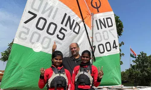 Vaishnavi Veeravamsham and Jhansipriya Laveti, sailors of Telangana,  with their coach Suheim Sheikh