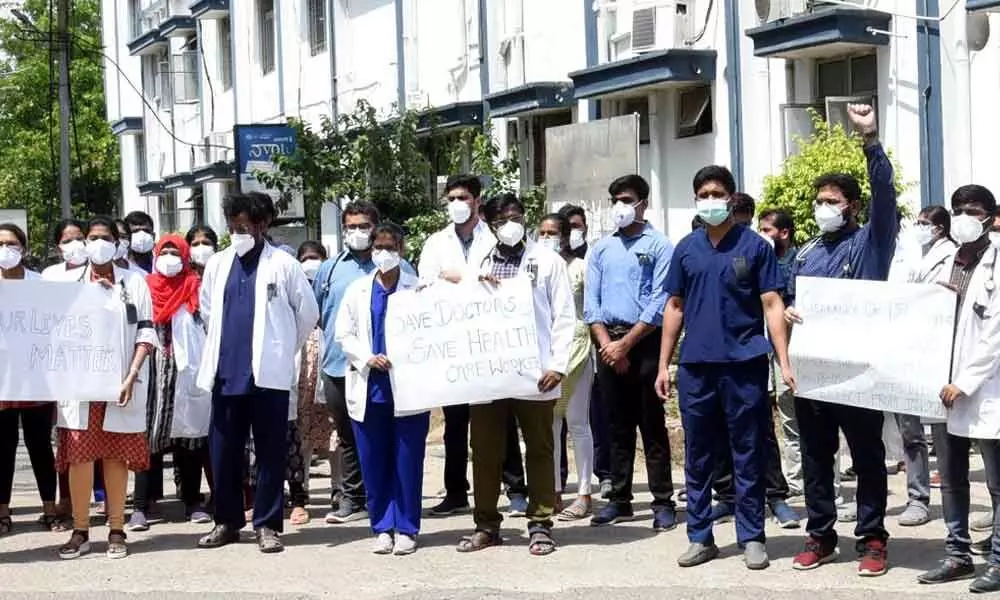 Junior doctors staging a protest on the premises of MGM hospital in Warangal on Wednesday
