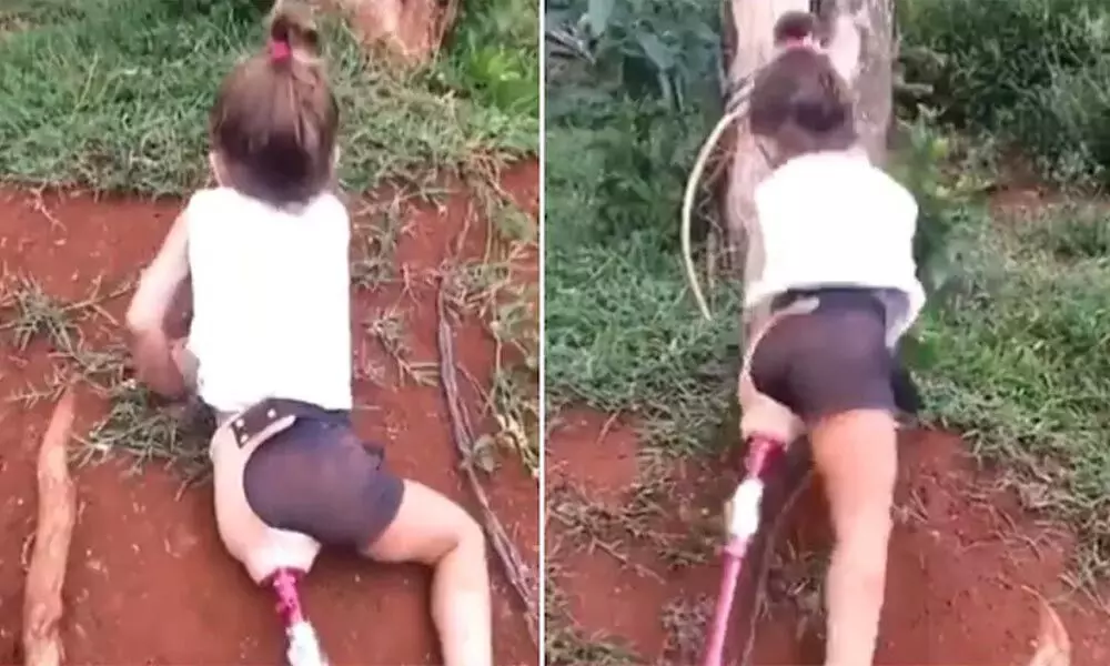 A viral video shows a girl with a prosthetic leg climbing over a ditch.