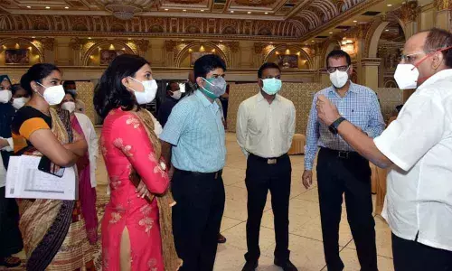Chief Secretary Somesh Kumar interacting with doctors at the special vaccination centre for high-risk individuals at Red Rose function hall in Hyderabad on Friday