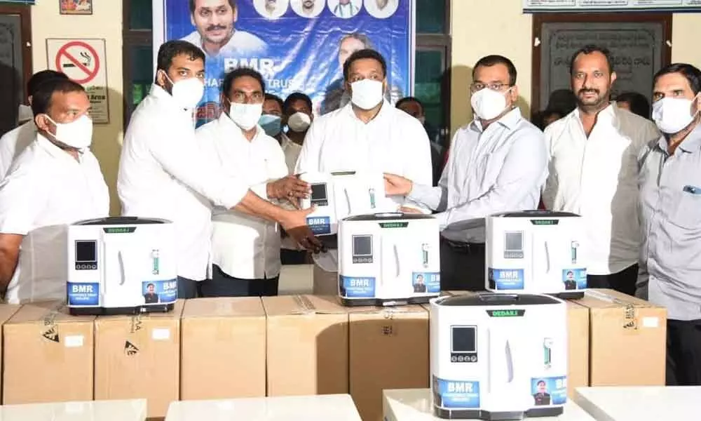 BMR Trust Chairman Beeda Mastan Rao, along with Ministers  Anil Kumar and M Goutham Reddy, handing over 250 oxygen concentrators to the Collector K V N Chakradhar Babu in Nellore on Saturday