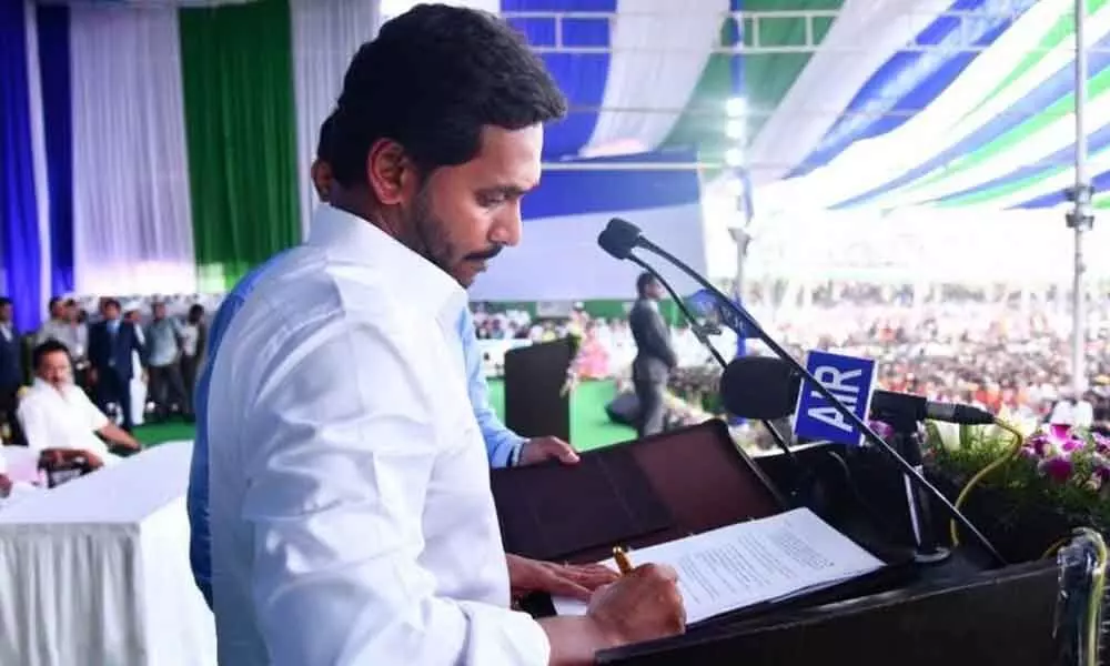 Chief Minister Y S Jagan Mohan Reddy signs the file increasing old age pension after taking oath of office  on May 30, 2019