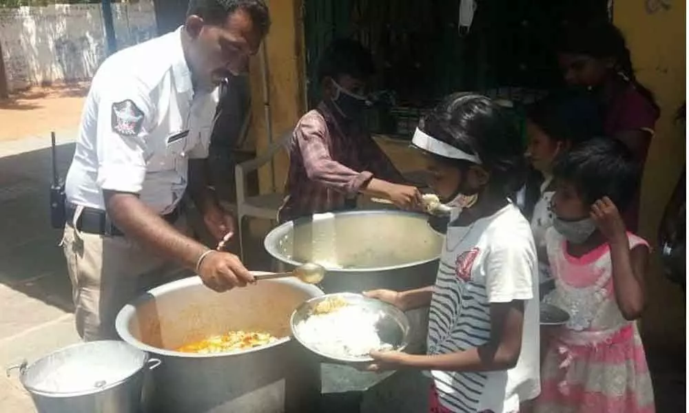 Traffic constable K Chinna Sunkanna serving food to destitute and orphan children in Kurnool on Sunday