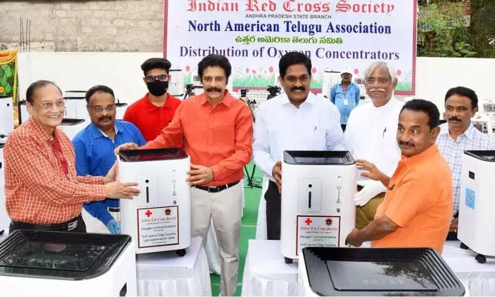 Principal Secretary of Transport and R&B MT Krishna Babu along with Indian Red Cross Society State president Dr A Sridhar Reddy, Krishna district president Dr G Samaram receiving oxygen concentrators donated by the North America Telugu Association in Vijayawada on Monday