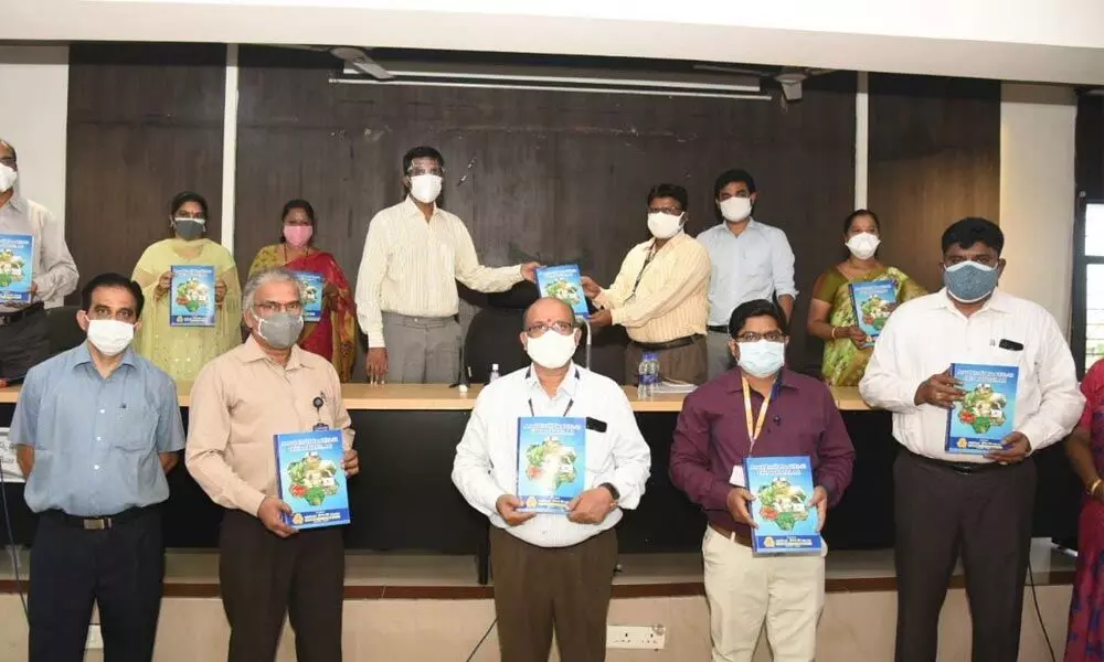 District Collector M Harinarayanan and officials of various departments displaying copies of annual credit plan for 2021-22 at the Collectorate  in Chittoor on Tuesday