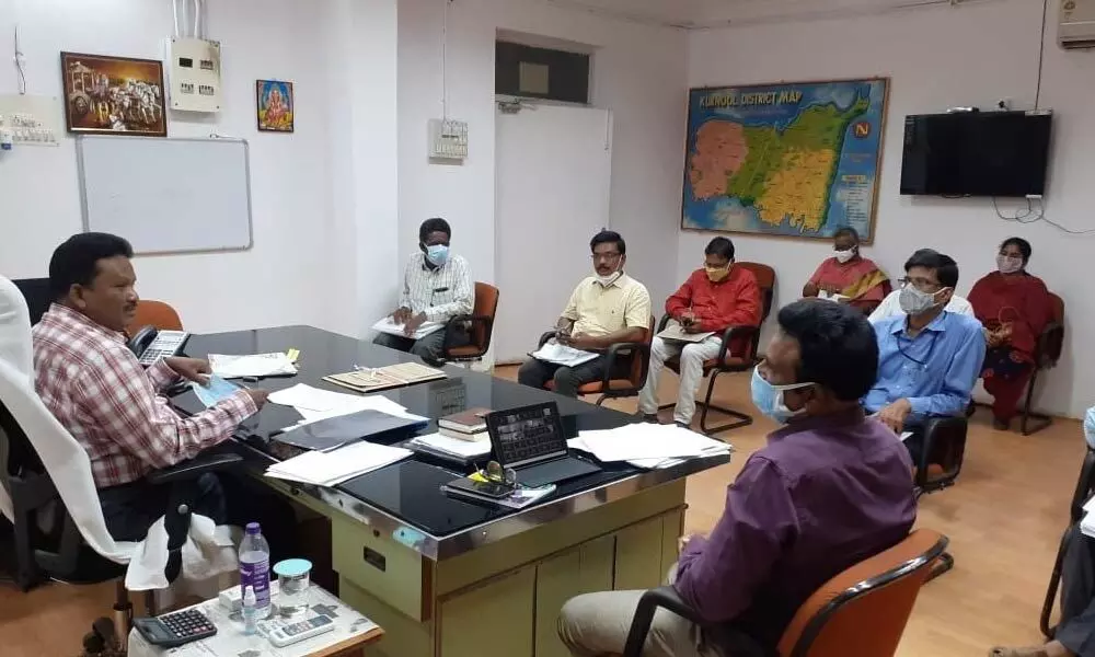 Joint Collector MVK Sriniasulu addressing a meeting on provision of works under MGNREGA with the staff concerned at his chamber in Kurnool on Tuesday