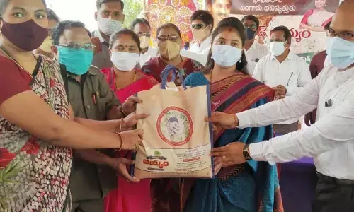 Deputy Chief Minister  P Pushpasreevani distributing fortified rice to people in Kurupam in Vizianagaram district on Tuesday