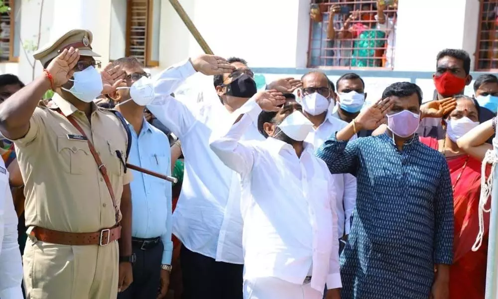 Energy Minister G Jagadish Reddy along with District Collector T Vinay Krishna Reddy salutes national flag during the State Formation Day celebrations in Suryapet on Wednesday