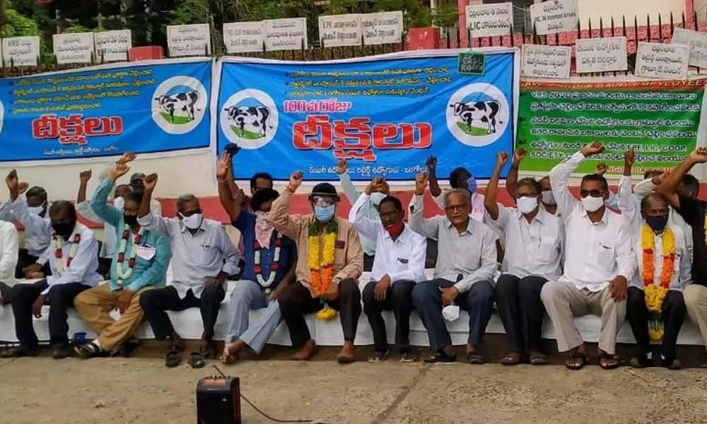 Ongole dairy workers and employees staging a protest at Collectorate in Ongole on Thursday