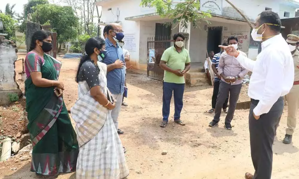 District Collector RV Karnan giving directions to the officials concerned on Covid cases at Koyachilaka village on Friday