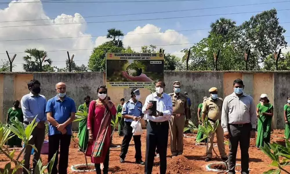 VSEZ Development Commissioner A Rama Mohan Reddy and other staff members planting saplings on their office premises at Duvvada on the occasion of the World Environment Day on Saturday
