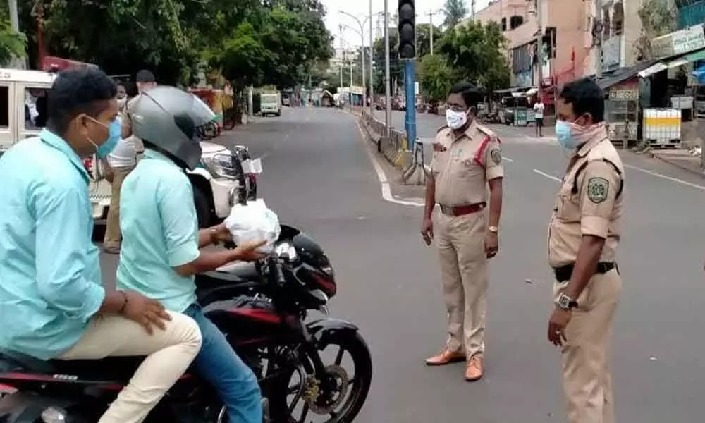 Police checking the commuters during the partial curfew time in Visakhapatnam