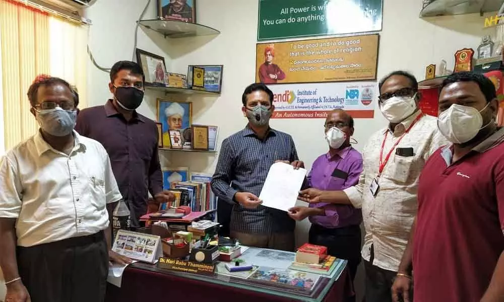 T Haribabu with the colleagues of Lendi college, showing the copy of order issued by JNTU