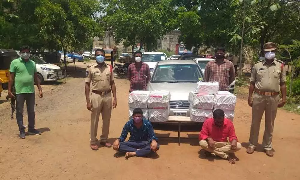 Police producing the seized ganja and the accused before the media in Bhadrachalam on Monday