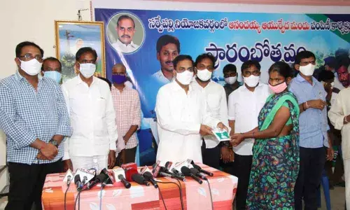 Sarvepalli MLA K Govardhan Reddy distributing Anandaiahs concoction at Golagamudi in Nellore district on Monday