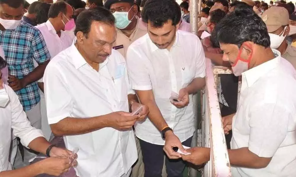 MP Magunta Srinivasulu Reddy and his son Raghava Reddy explaining the method to consume Anandaiahs miracle mix in Ongole on Thursday