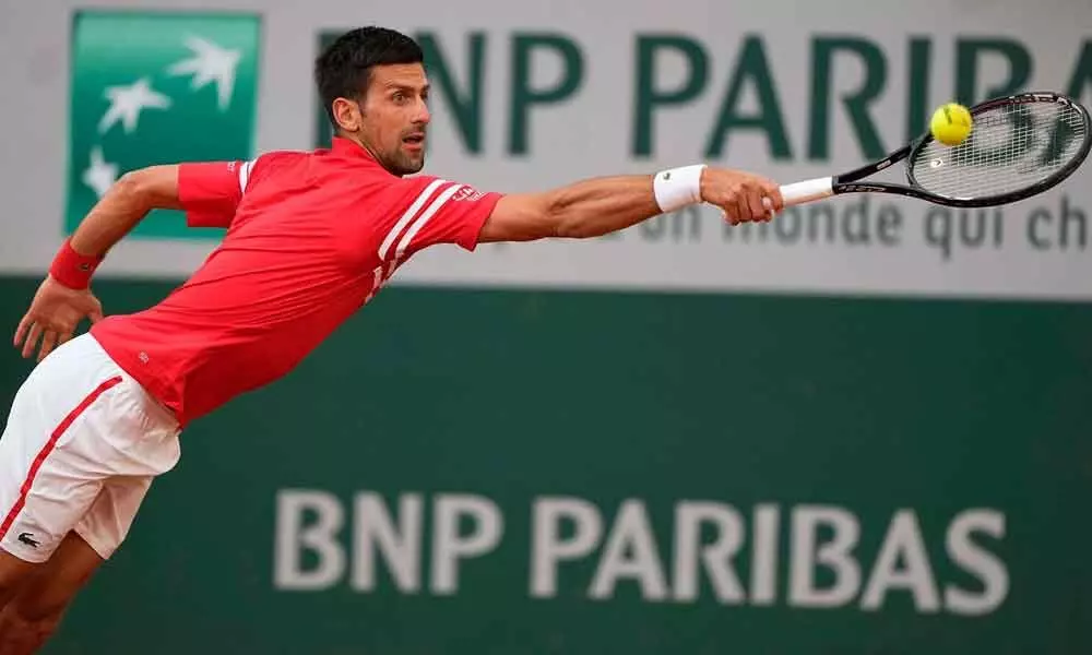 Djokovic sets up semis clash with Nadal in French Open