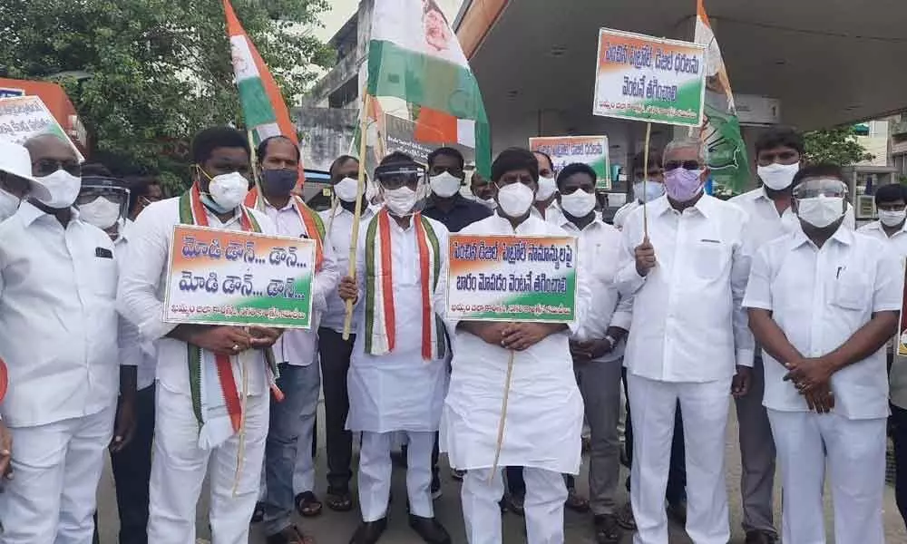 CLP leader Mallu Bhatti Vikramarka along with Congress leaders staging a protest before a petrol bunk in Khammam on Friday