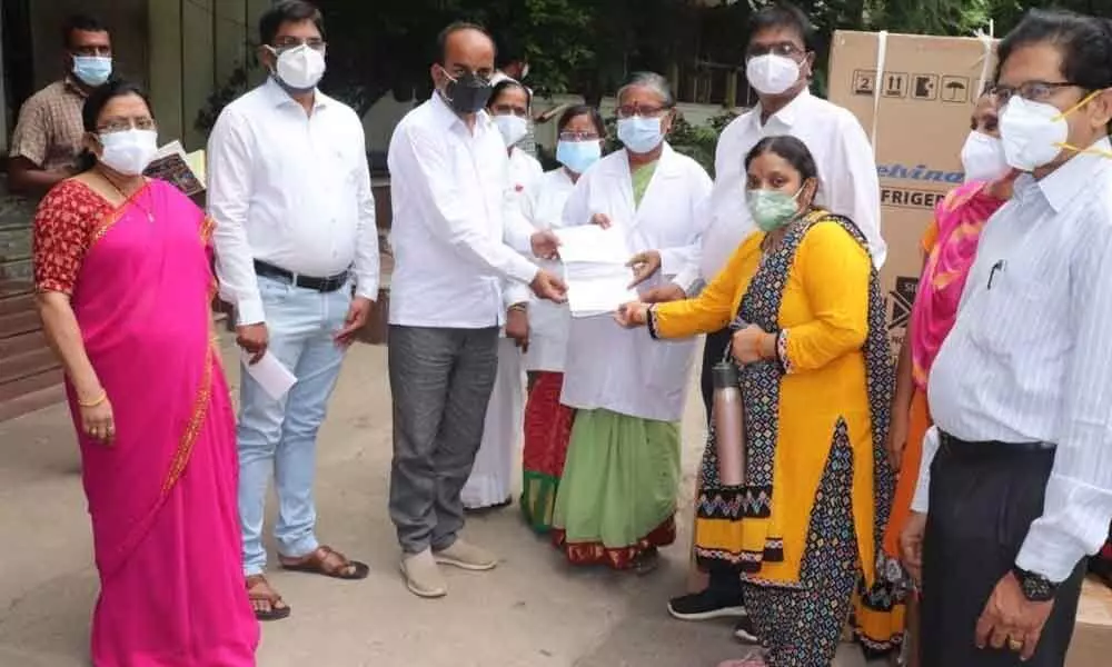 NRI patient Sirisha Hari Kumar and BJP leader K Ajay Kumar donating equipment to Ruia hospital superintendent Dr T Bharathi in Tirupati on Friday.