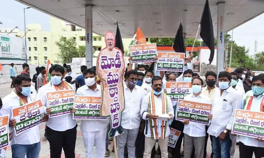 Warangal DCC president Naini Rajender Reddy along with Congress leaders staging a protest at a petrol bunk in Warangal on Friday