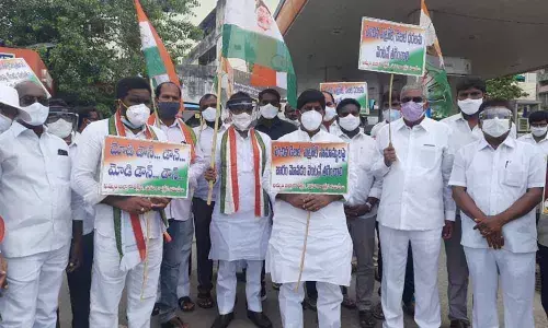 CLP leader Mallu Bhatti Vikramarka along with Congress leaders staging a protest before a petrol bunk in Khammam on Friday