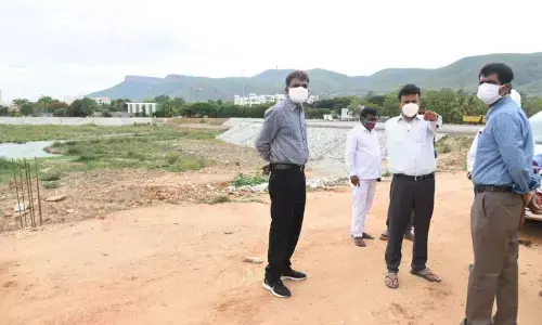 Collector M Harinarayanan along with Municipal Commissioner P S Girisha inspecting Vinayak Sagar development works in Tirupati on Saturday
