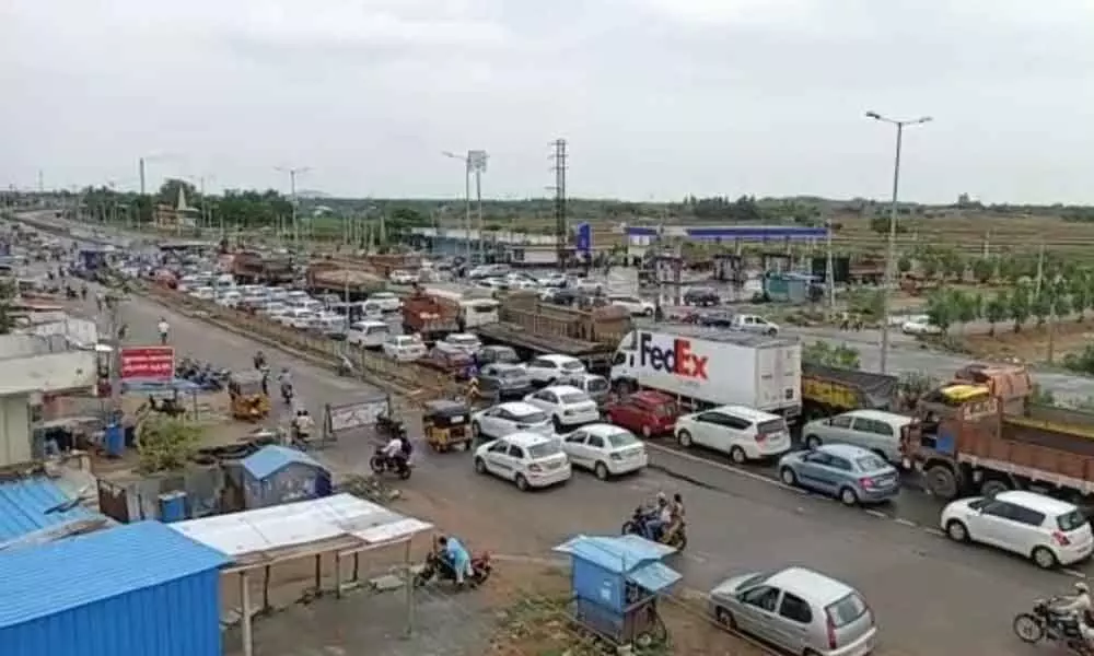 Vehicles stranded at Andhra-Telangana border check-post near Ramapuram village in Nalgonda district on Sunday