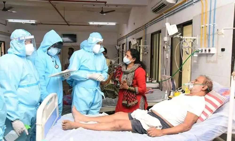 MLA Bhumana Karunakar Reddy interacting with a patient at Ruia hospital in Tirupati on Monday