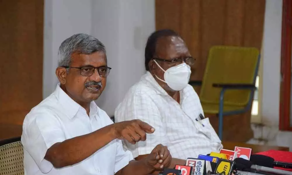 APUCF convenor Ch Babu Rao along with CPM leader Donepudi Kasinath addressing the media in Vijayawada on Monday