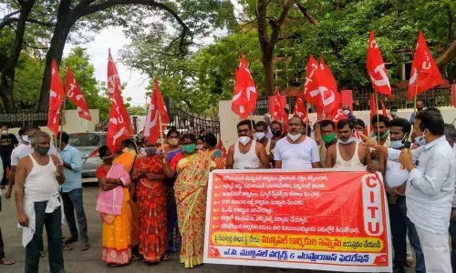 Municipal workers staging protest in front of the district Collectorate in Ongole on Tuesday
