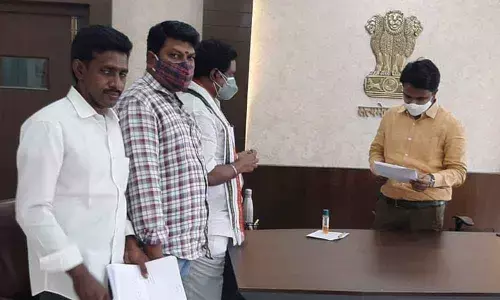 City Congress Committee president Naraharisetti Narasimha Rao submitting a memorandum to Municipal Commissioner Prasanna Venkatesh