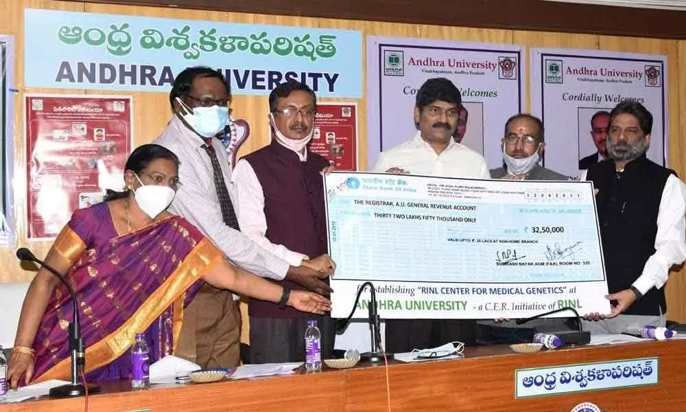 RINL In-charge CMD and Director (Personnel) K C Das handing over a cheque to Vice-Chancellor of Andhra University PVGD Prasada Reddy  in Visakhapatnam on Saturday