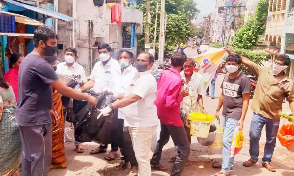 Congress leaders collecting garbage from shops in Visakhapatnam on Saturday as part of their protest