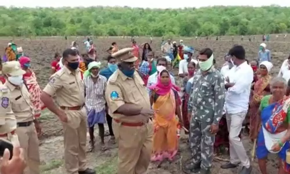 Forest officials trying to stop podu farmers from sowing of seeds in Sircilla on Saturday