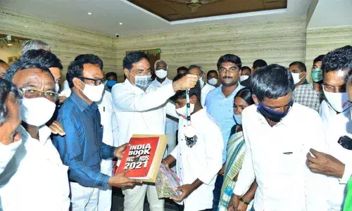 Minister for Panchayat Raj Errabelli Dayakar Rao felicitating a student Marathi Aravind, who entered the India Book of Records-2021, in Warangal on Saturday