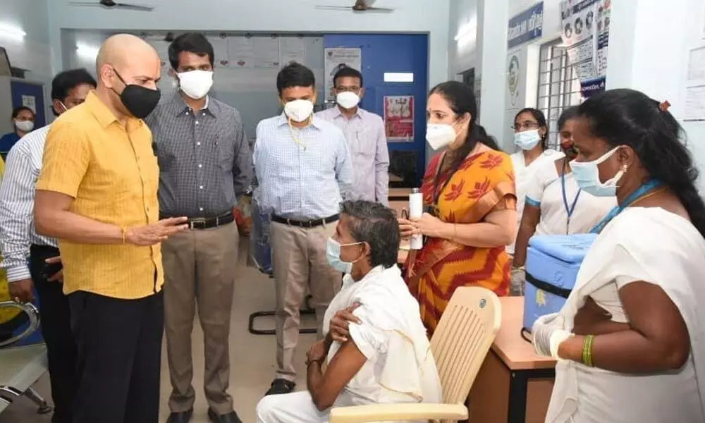 Principal Secretary (Health) Anil Kumar Singhal speaking to an aged woman who received a Covid jab at the PHC at Nehru Nagar  in Tirupati  on Sunday