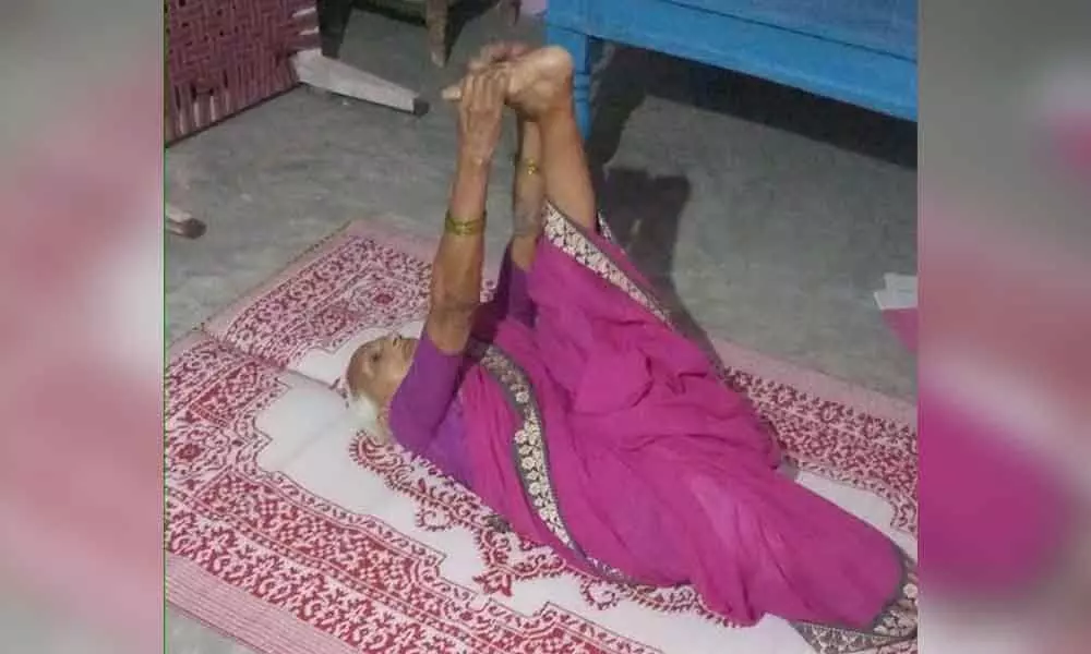 Octogenarian, Jeeguru Kanakalakshmi of Kolanur village, practicing yoga