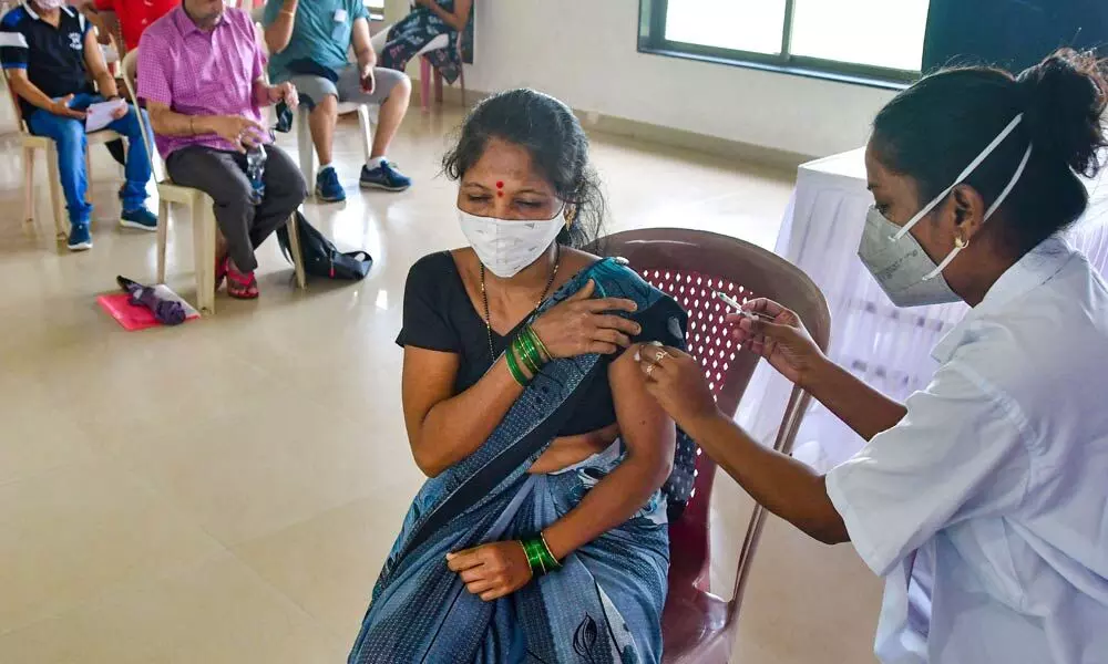 A health worker administers a dose of Covid-19 vaccine, at a vaccination centre at Priyadarshani Park, in Mumbai on Monday