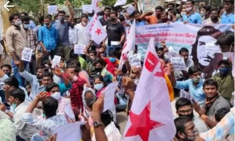 DYFI, SFI leaders and other unemployed youth staging a protest in front of collectorate in Kurnool on Monday