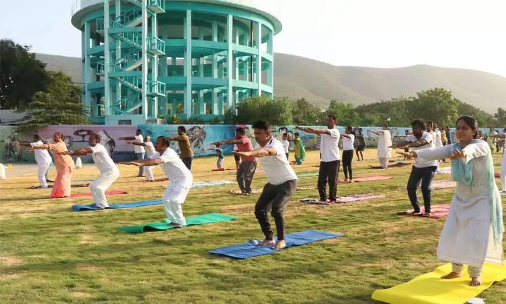Municipal Commissioner P S Girisha, Mayor Dr R Sirisha and others practising yogasanas in Tirupati on Monday.